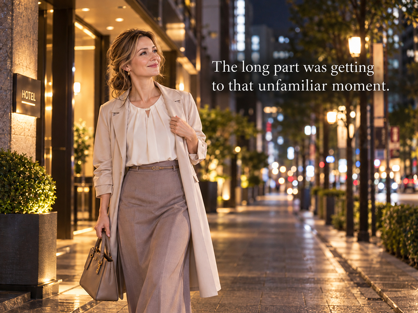 A woman walking alone along a softly lit city street at night with a calm expression